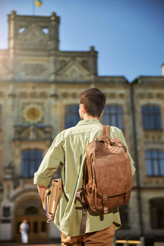 young-dark-haired-man-with-textbooks-going-ahead-2025-03-06-16-05-20-utc